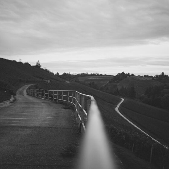 A black and white photo of a long road