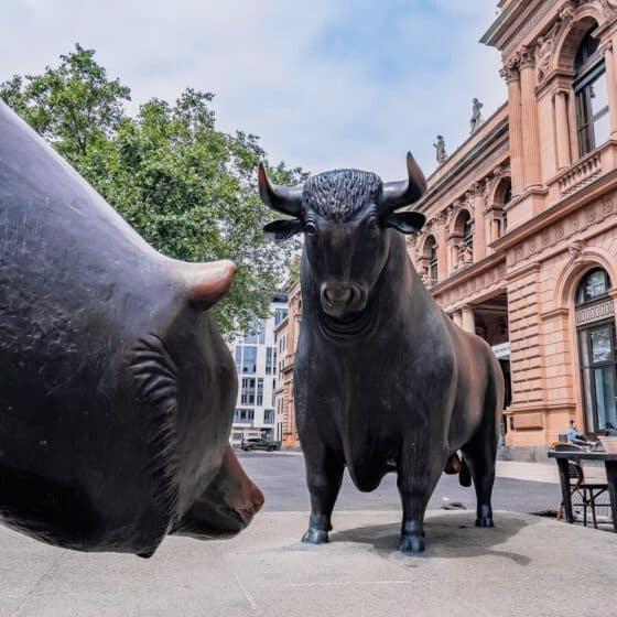 a statue of a bull and a bull's head in front of a building
